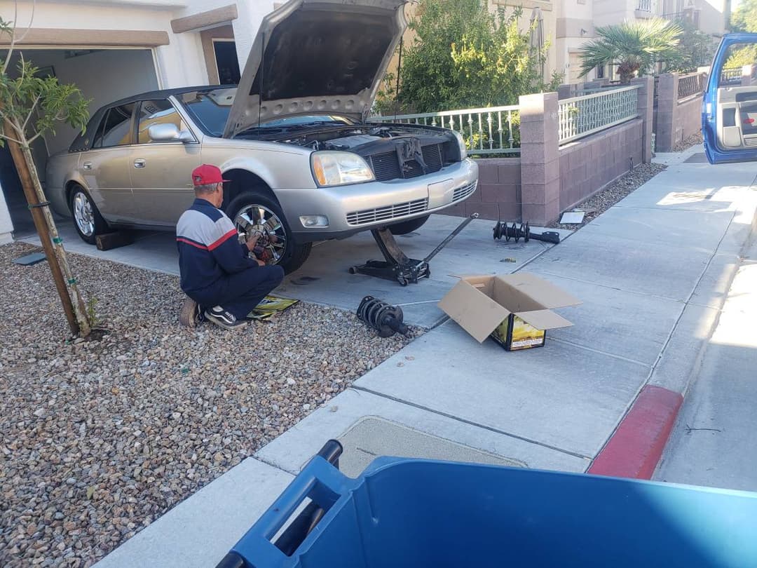 picture of a mobile mechanic doing the brakes on a car